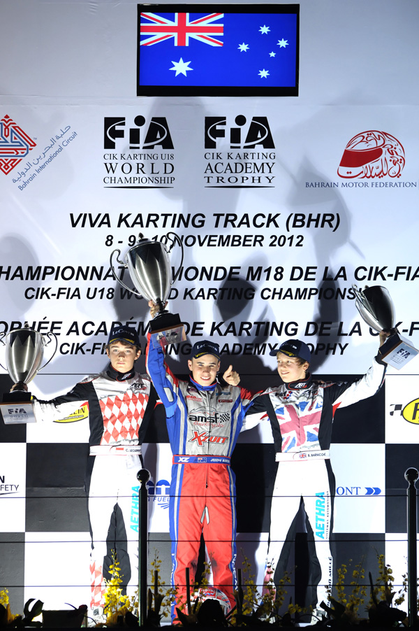Mawson (middle) on top of the podium after winning the final round of the 2012 CIK-FIA Under 18 World Karting Championship in Bahrain (Pic: KSP)